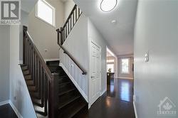 The elegant hardwood staircase leads to the 2nd level. - 