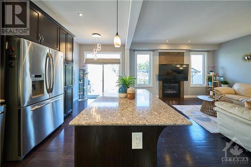 The chef’s kitchen is equipped with SS appliances, high-quality quartz countertops, and a central island. - 540 Dundonald Drive, Ottawa, ON - Indoor