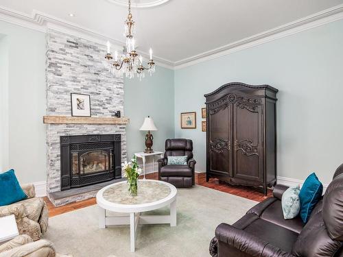 Living room - 338  - 342 Rue St-Eustache, Saint-Eustache, QC - Indoor Photo Showing Living Room With Fireplace