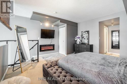 715 - 250 Manitoba Street, Toronto, ON - Indoor Photo Showing Bedroom With Fireplace
