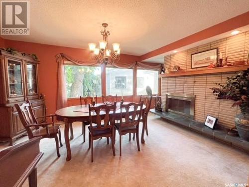 1109 Bothwell Drive, Swift Current, SK - Indoor Photo Showing Dining Room With Fireplace