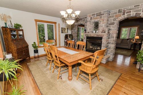 85 Heritage Drive, Dufferin, MB - Indoor Photo Showing Dining Room With Fireplace