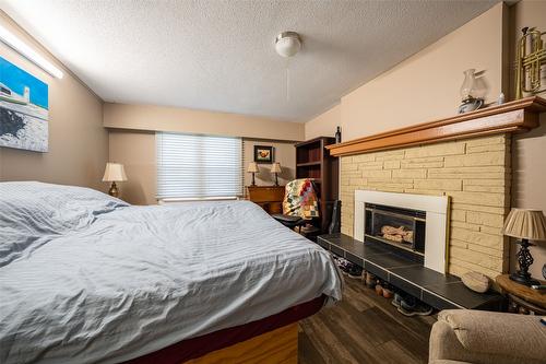 2505 Henderson Drive, Armstrong, BC - Indoor Photo Showing Bedroom With Fireplace