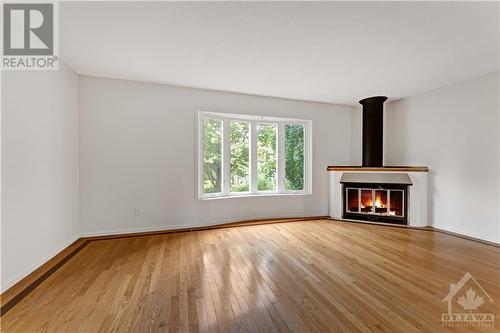 6339 Long Bow Gate, Ottawa, ON - Indoor Photo Showing Living Room With Fireplace