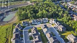 Far drone view of the home (the one with square design driveway) - 