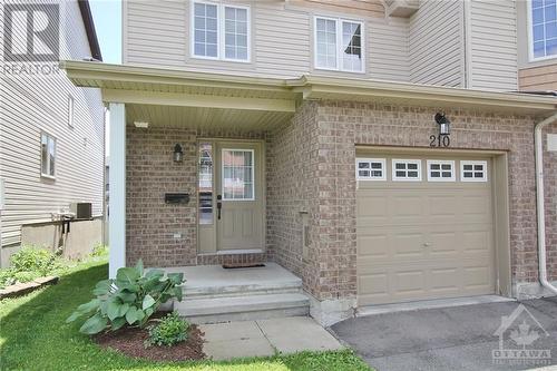 Welcoming covered front porch entry, ideal for relaxing or greeting guests. Inside entry from garage. - 210 Rolling Meadow Crescent, Ottawa, ON 