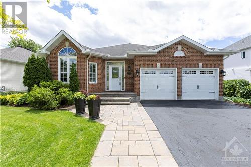 Truly a rare find! This stunning Braebury 1787sq ft detached bungalow is one of the larger floor plans in highly sought after Springridge. Interlock walkway and double car garage. - 1854 Springridge Drive, Ottawa, ON - Outdoor With Facade
