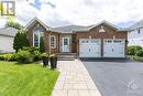 Truly a rare find! This stunning Braebury 1787sq ft detached bungalow is one of the larger floor plans in highly sought after Springridge. Interlock walkway and double car garage. - 1854 Springridge Drive, Ottawa, ON  - Outdoor With Facade 