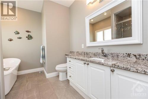 Lavish 4 piece ensuite with a stand-alone tub and glass shower - 1854 Springridge Drive, Ottawa, ON - Indoor Photo Showing Bathroom
