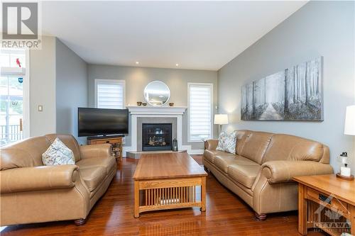 Living room with cozy gas fireplace - 1854 Springridge Drive, Ottawa, ON - Indoor Photo Showing Living Room With Fireplace