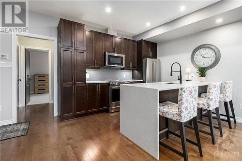 Main floor kitchen overlooking the living room and dining room - 129 Eye Bright Crescent, Ottawa, ON 