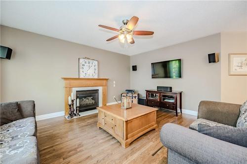 Family room has hardwood floors and built-in surround sound speakers - 61 Richmond Crescent, Stoney Creek, ON - Indoor Photo Showing Living Room With Fireplace