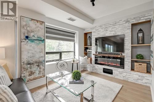 304 - 200 Burnhamthorpe Road E, Mississauga, ON - Indoor Photo Showing Living Room With Fireplace