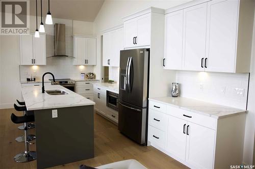 323 Woolf Bay, Saskatoon, SK - Indoor Photo Showing Kitchen With Stainless Steel Kitchen With Double Sink With Upgraded Kitchen