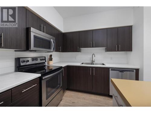 975 Academy Way Unit# 401, Kelowna, BC - Indoor Photo Showing Kitchen With Double Sink