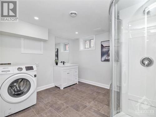 Combination laundry room and 3-piece bathroom. - 1326 Woodward Avenue, Ottawa, ON - Indoor Photo Showing Laundry Room