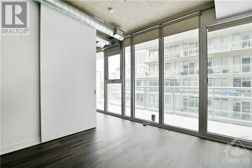 LIVING SPACE | floor to ceiling wall to wall windows, into the bedroom, provide abundant natural light - 354 Gladstone Avenue Unit#502, Ottawa, ON 