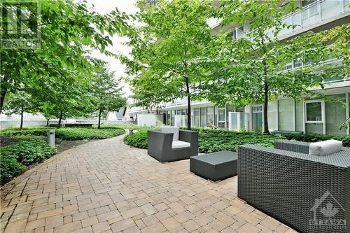 AMENITIES | 'rooftop' terrace has interlock pathway with multiple seating areas - 354 Gladstone Avenue Unit#502, Ottawa, ON 