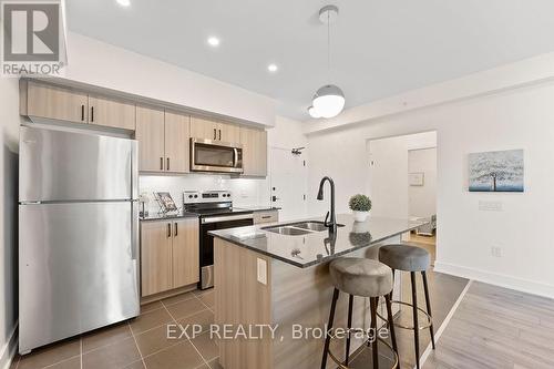 506 - 4 Spice Way, Barrie, ON - Indoor Photo Showing Kitchen With Stainless Steel Kitchen With Double Sink With Upgraded Kitchen