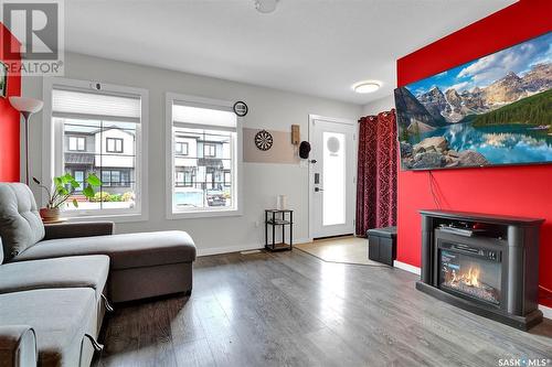 108 2715 Narcisse Drive, Regina, SK - Indoor Photo Showing Living Room With Fireplace