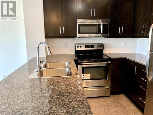 611 - 15 James Finlay Way, Toronto (Downsview-Roding-Cfb), ON - Indoor Photo Showing Kitchen With Stainless Steel Kitchen With Double Sink With Upgraded Kitchen