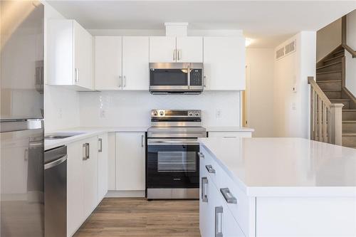 Kitchen with quartz counters & backsplash - 4263 Fourth Avenue|Unit #821, Niagara Falls, ON - Indoor Photo Showing Kitchen