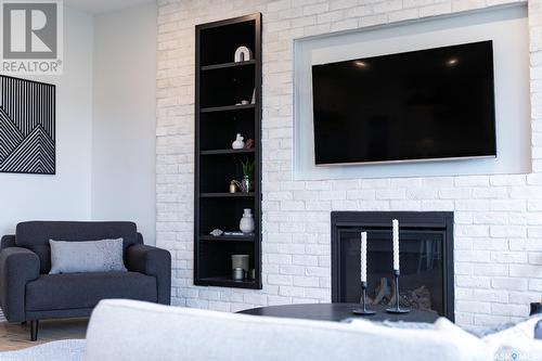 12 Plains Green, Pilot Butte, SK - Indoor Photo Showing Living Room With Fireplace