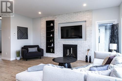 12 Plains Green, Pilot Butte, SK - Indoor Photo Showing Living Room With Fireplace