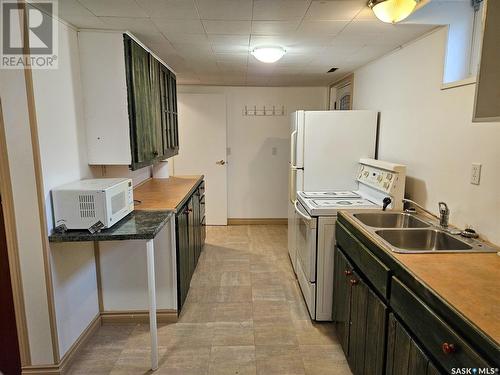 210 1St Street W, Frontier, SK - Indoor Photo Showing Kitchen With Double Sink