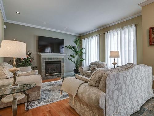 Salle familiale - 7655 Rue Liege, Brossard, QC - Indoor Photo Showing Living Room With Fireplace