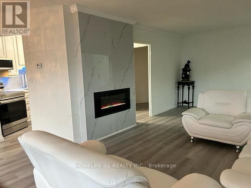 516 - 60 Pavane Link Way, Toronto, ON - Indoor Photo Showing Living Room With Fireplace