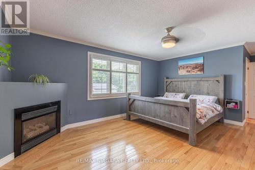 3 Brock Street, Thorold, ON - Indoor Photo Showing Bedroom With Fireplace