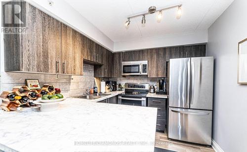 306 - 1450 Bishops Gate, Oakville (Glen Abbey), ON - Indoor Photo Showing Kitchen With Stainless Steel Kitchen With Double Sink