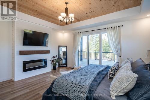 13199 16 County Road, Severn, ON - Indoor Photo Showing Bedroom With Fireplace