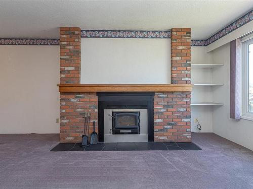 205-2286 Henry Ave, Sidney, BC - Indoor Photo Showing Living Room With Fireplace