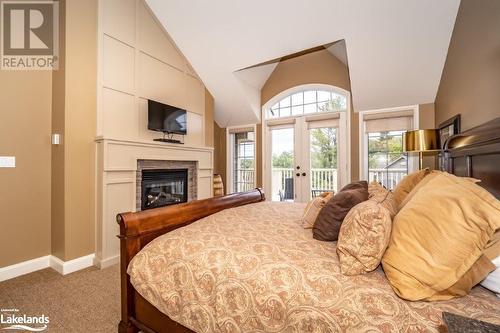 3876 Muskoka 118 Road Unit# Sandfield 6 W5, Port Carling, ON - Indoor Photo Showing Bedroom With Fireplace