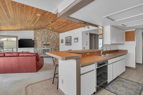 209-4340B Beach Avenue, Peachland, BC - Indoor Photo Showing Kitchen With Fireplace With Double Sink