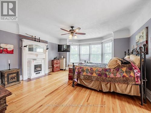 65 Albert Street N, Kawartha Lakes, ON - Indoor Photo Showing Bedroom With Fireplace