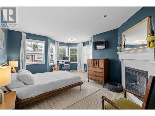 380 Providence Avenue Unit# 9, Kelowna, BC - Indoor Photo Showing Bedroom With Fireplace