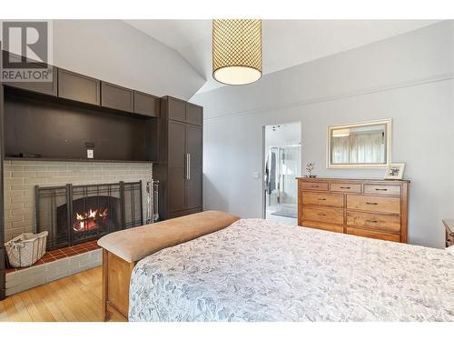 694 Mcclure Road, Kelowna, BC - Indoor Photo Showing Bedroom With Fireplace