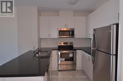 619 - 7325 Markham Road, Markham (Cedarwood), ON - Indoor Photo Showing Kitchen With Double Sink With Upgraded Kitchen