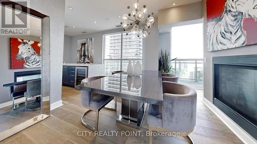 Uph4103 - 33 Shore Breeze Drive, Toronto W06, ON - Indoor Photo Showing Dining Room With Fireplace