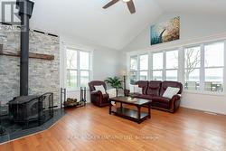 Living Room with Wood Stove and Picture Windows - 