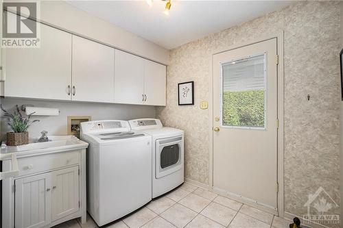 Main floor laundry with access to your fenced side yard - 5 Springwood Circle, Ottawa, ON - Indoor Photo Showing Laundry Room