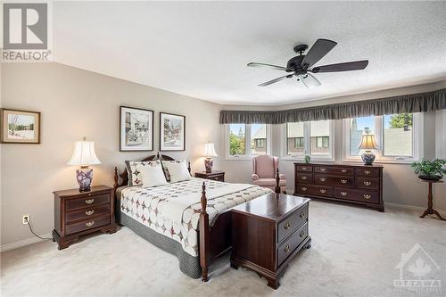 Through double doors, a very expansive primary bedroom with wall to wall windows at the back of the home - 5 Springwood Circle, Ottawa, ON - Indoor Photo Showing Bedroom