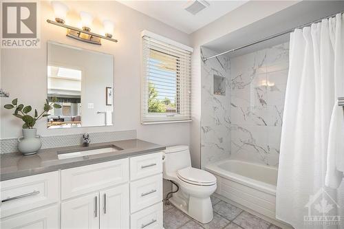 Beautifully updated main bathroom with quartz countertops and gorgeous tile choices - 5 Springwood Circle, Ottawa, ON - Indoor Photo Showing Bathroom