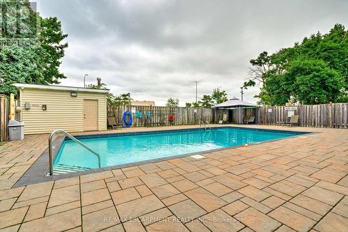1214 - 700 Dynes Road, Burlington, ON - Outdoor With In Ground Pool With Backyard