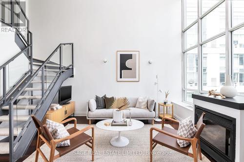 703 - 250 Manitoba Street, Toronto, ON - Indoor Photo Showing Living Room With Fireplace