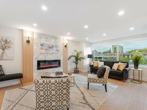 214-475 The West Mall, Toronto, ON - Indoor Photo Showing Living Room With Fireplace