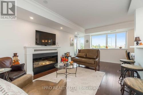 208 - 200 Halton Hills Drive, Halton Hills (Georgetown), ON - Indoor Photo Showing Living Room With Fireplace